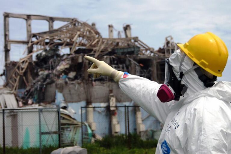 An IAEA inspector surveys damage at the Fukushima plant's Reactor Unit 3 Credit: socialistworker.org | Greg Webb