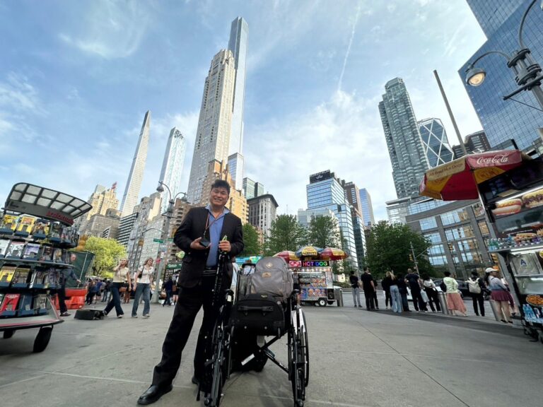 In March of this year, following five months of hospitalization and rehabilitation for Guillain-Barré Syndrome, the author traveled to New York for a reporting assignment, carrying camera equipment and a laptop on a wheelchair. He is deeply grateful to the colleague, flight attendants, emergency medical staff, doctors, nurses, physical therapists, and occupational therapists who helped save his life. Credit: Kevin Lin