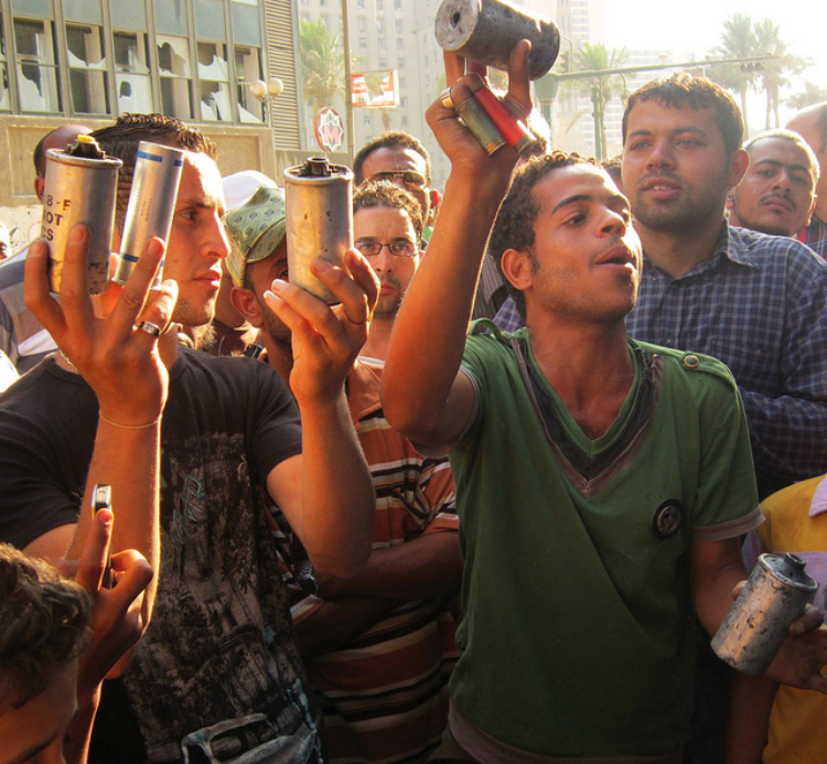 Demonstrators in Cairo hold up used tear gas shells. Credit: Cam McGrath/IPS