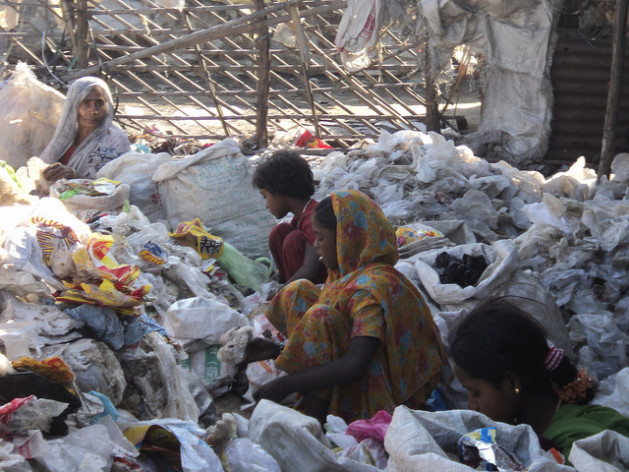 Women ragpickers in Delhi scavenging through a pile of refuse for recyclable material. Credit: Dharmendra Yadav/IPS