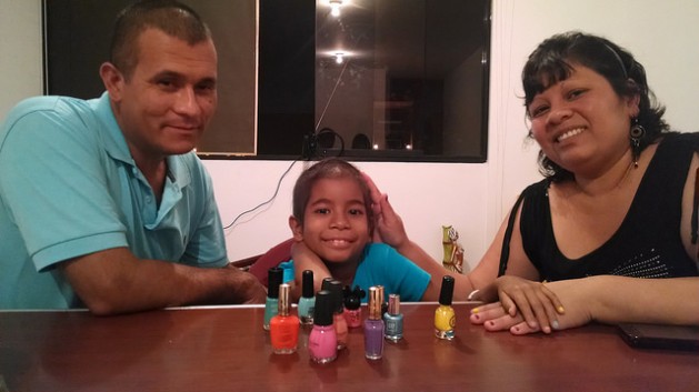 Claudia Alvarado, with her parents and her nail polish, who along with Peru’s Plan Esperanza have helped her to bravely face the treatment for leukaemia. Credit: Milagros Salazar/IPS