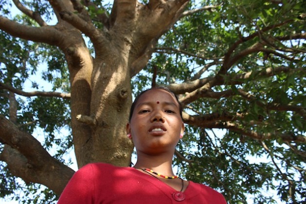 Every morning Raj Kumari Chaudhari offers prayers to this mango tree where she took shelter during the floods in 2014 in mid-west Nepal. Credit: Mallika Aryal/IPS