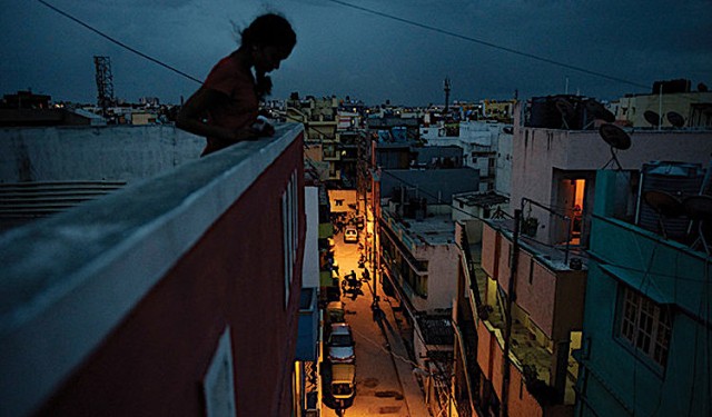 Photo: Girl on roof of a factory in India. Source: UNFPA © Andrea Bruce/Noor