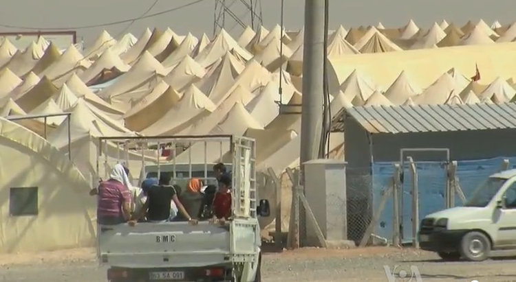 Photo: Syrian refugee camp on the Turkish border for displaced people of the Syrian civil war. Source: Wikimedia Commons