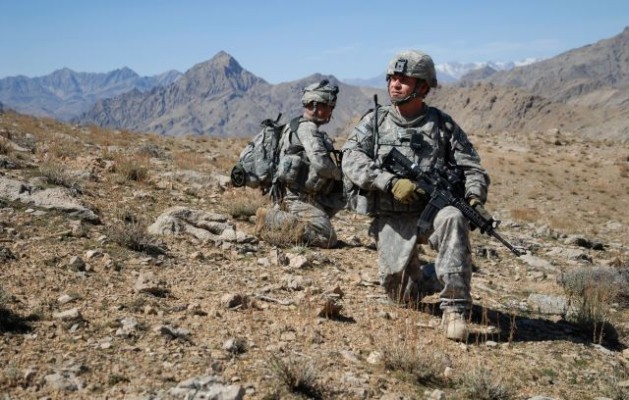 U.S. Army Staff Sgt. Salvador Lopez (right) and Spc. Ashley Shaw, both assigned to 1st Battalion, 4th Infantry Regiment, U.S. Army Europe, take a knee while descending a mountain ridge near Forward Operation Base Lane in Zabul province, Afghanistan, on March 8, 2009. DoD photo by Staff Sgt. Adam Mancini, U.S. Army. (Released)