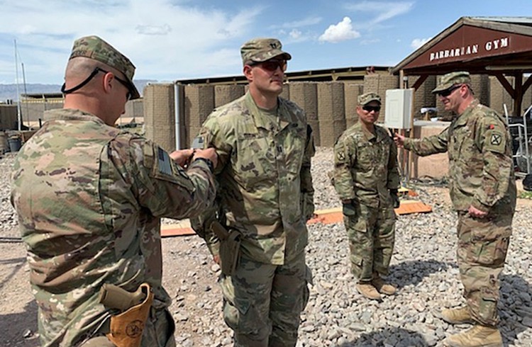 Photo: Capt. Matthew Dixon, who deployed with the 1st Battalion, 87th Infantry of the 10th Mountain Division, receives a combat patch during his deployment to Afghanistan during the spring of 2020. U.S. ARMY