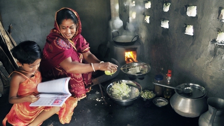 Photo: Ms. Shefali Ghosh from Savar, near Dhaka, teaches her daugher in the kitchen. Credit: The World Bank