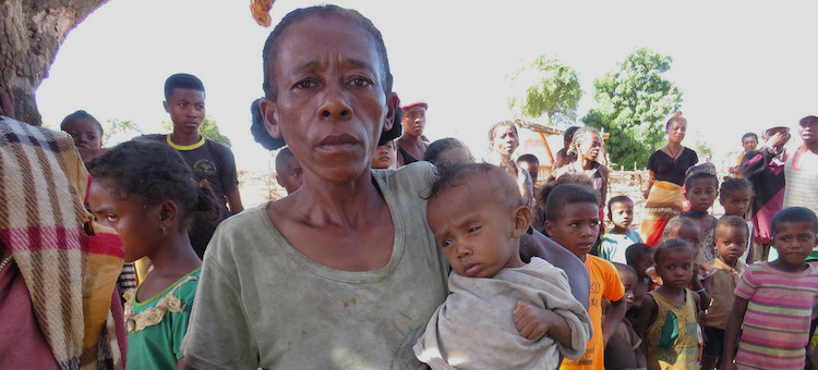 Photo: A mother waits to receive food for her child in drought-affected southern Madagascar. © WFP/Fenoarisoa Ralaiharinony