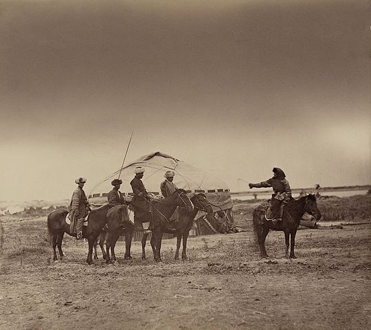a woman and four men on horseback. May be an example of the tradition of capturing or "kidnapping" a bride./ Public Domain