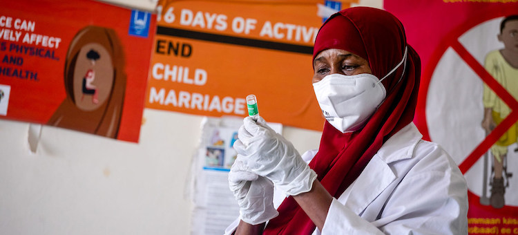 Photo: A healthcare worker prepares a COVID-19 vaccine at a hospital in Mogadishu, Somalia. © UNICEF/Ismail Taxta