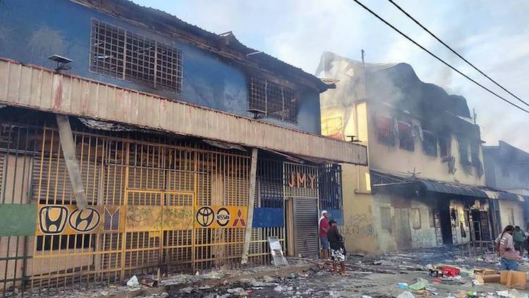 Photo: Chinatown in Honiara, with some buildings burning. Credit: Georgina Kekea, NZ Herald
