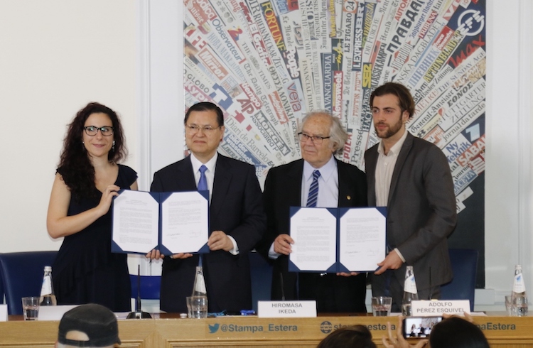 Photo: SGI Vice President Hiromasa Ikeda (2nd from left) and Dr. Pérez Esquivel (2nd from right) with two youth representatives presenting joint appeal at a press conference at Rome’s Foreign Press Association on June 5, 2018. Credit: Seikyo Shimbun.