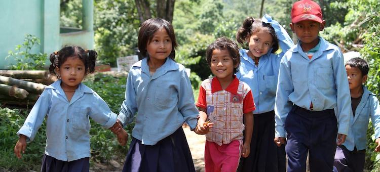 Photo: A group of school children walk hand in hand after school in rural Nepal. © World Bank/Aisha Faquir