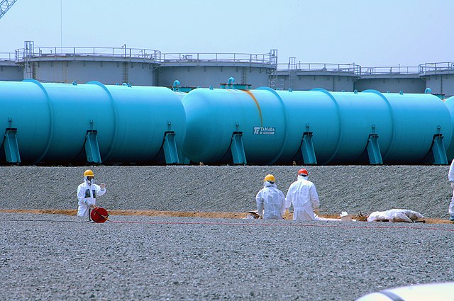 Workers at TEPCO's Fukushima Daiichi Nuclear Power Station work among underground water storage pools on 17 April 2013. Two types of above-ground storage tanks rise in the background. An IAEA expert team visited the site on 17 April 2013 as part of a mission to review Japan's plans to decommission the facility. Photo Credit: Greg Webb / IAEA