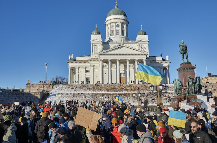 Photo: Protestors at a February 2022 rally against Russia's invasion of Ukraine march past the statue of Tsar Alexander II in Senate Square in Helsinki. CC BY 2.0