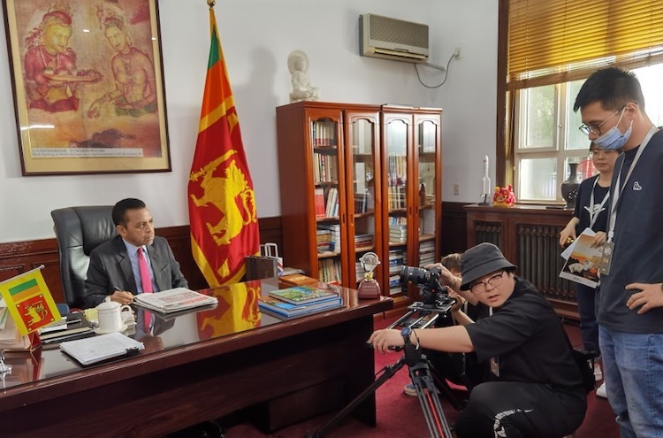 Photo: Ambassador Palitha Kohona with Chinese TV film crew at his office in Beijing.