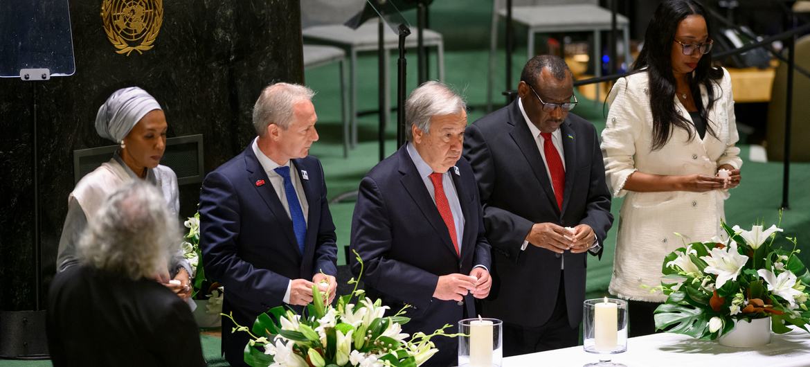 UN Photo/Loey Felipe Secretary-General António Guterres (centre) and other participants light candles at the UN General Assembly event commemorating the International Day of Reflection on the 1994 Genocide against the Tutsi in Rwanda.